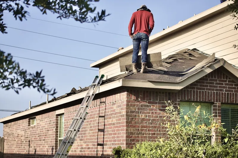 Professional roofer working on a residential roof in Johnston